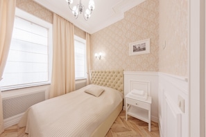 Relax in a stylish bedroom with a large bed, nightstand, and framed artwork.