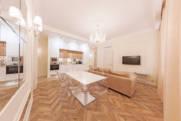 Relax in this stylish living space with a dining area, sofa, and flat-screen TV.