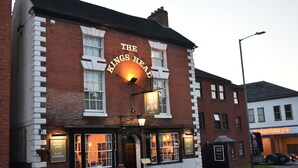 The Kings Head pub with a signboard, windows, and a car park sign. - The Kings Head Inn (Warwick)