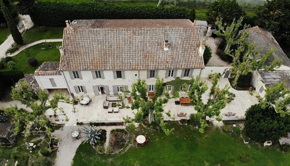 Stroll through the serene gardens surrounding this tranquil retreat, featuring a central entrance and beautifully maintained grounds.