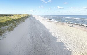 Enjoy the serene beach view with a wide sandy shore and expansive ocean vistas.