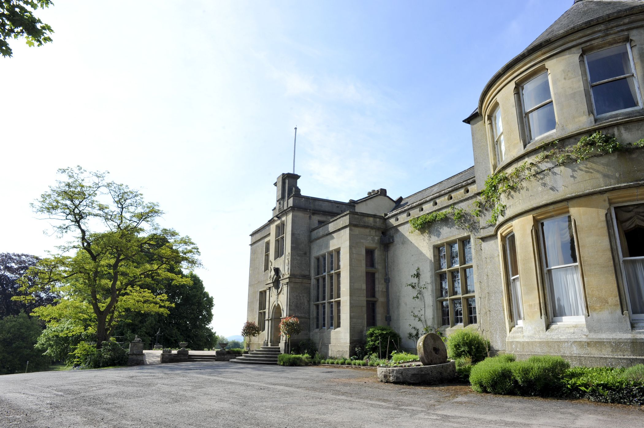 A large, historic building with a symmetrical facade, large windows, and a central entrance.