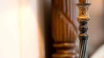 A close-up of a wooden balustrade with a metal handrail.