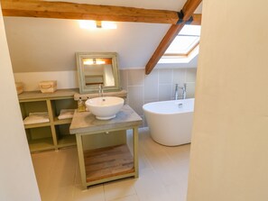 A bathroom with a white sink, a mirror, and a bathtub. - The Stable, Sedbury Park Farm (Richmond)