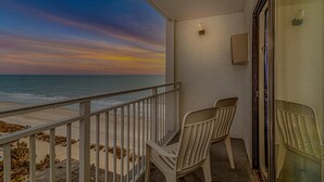 A balcony with a view of the ocean, a chair, and a small table. - Sea Mist 51408 (Myrtle Beach)