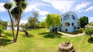 A light blue house with a large window and a small porch. - Helion Resort (Corfu)