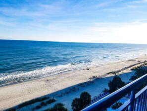 A beach with a fence, a clear sky, and calm sea. - Coral Beach 816 LOP (Myrtle Beach)
