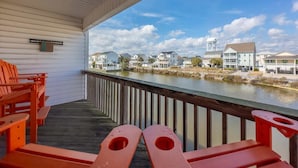 A covered outdoor area with a view of a water body and residential buildings. - Sea Pond Villa Unit 3 (North Myrtle Beach)