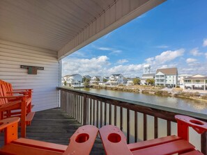 A covered outdoor area with a view of a water body and residential buildings. - Sea Pond Villa Unit 3 (North Myrtle Beach)