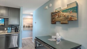 A modern kitchen with grey cabinets, a built-in coffee machine, and a dishwasher. - Sea Pond Villa Unit 3 (North Myrtle Beach)