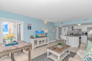 A modern kitchen with white cabinets, a microwave, and a refrigerator. - Palace 1810 (Myrtle Beach)