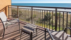 A balcony with a view of the beach, a chair, and a small table. - Caravelle 422 (Myrtle Beach)