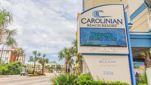 A sign for Carolinian Beach Resort with a digital display reading 'Welcome Snow Birds.' - Carolinian 731 (Myrtle Beach)