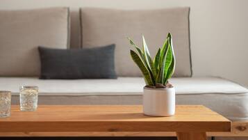 A wooden table with a potted plant and two glasses.