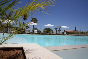 Seasonal outdoor pool, open 8:00 AM to 8:00 PM, pool umbrellas