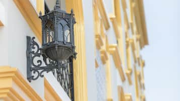 A building facade with ornate black lanterns and yellow trim.