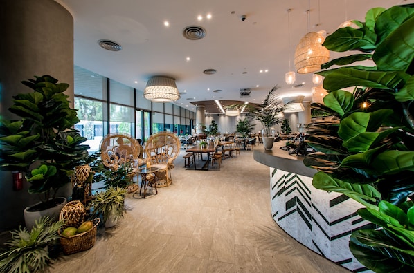 A spacious hotel lobby with modern furniture, large windows, and abundant greenery. - Village Hotel Sentosa by Far East Hospitality (Singapore)