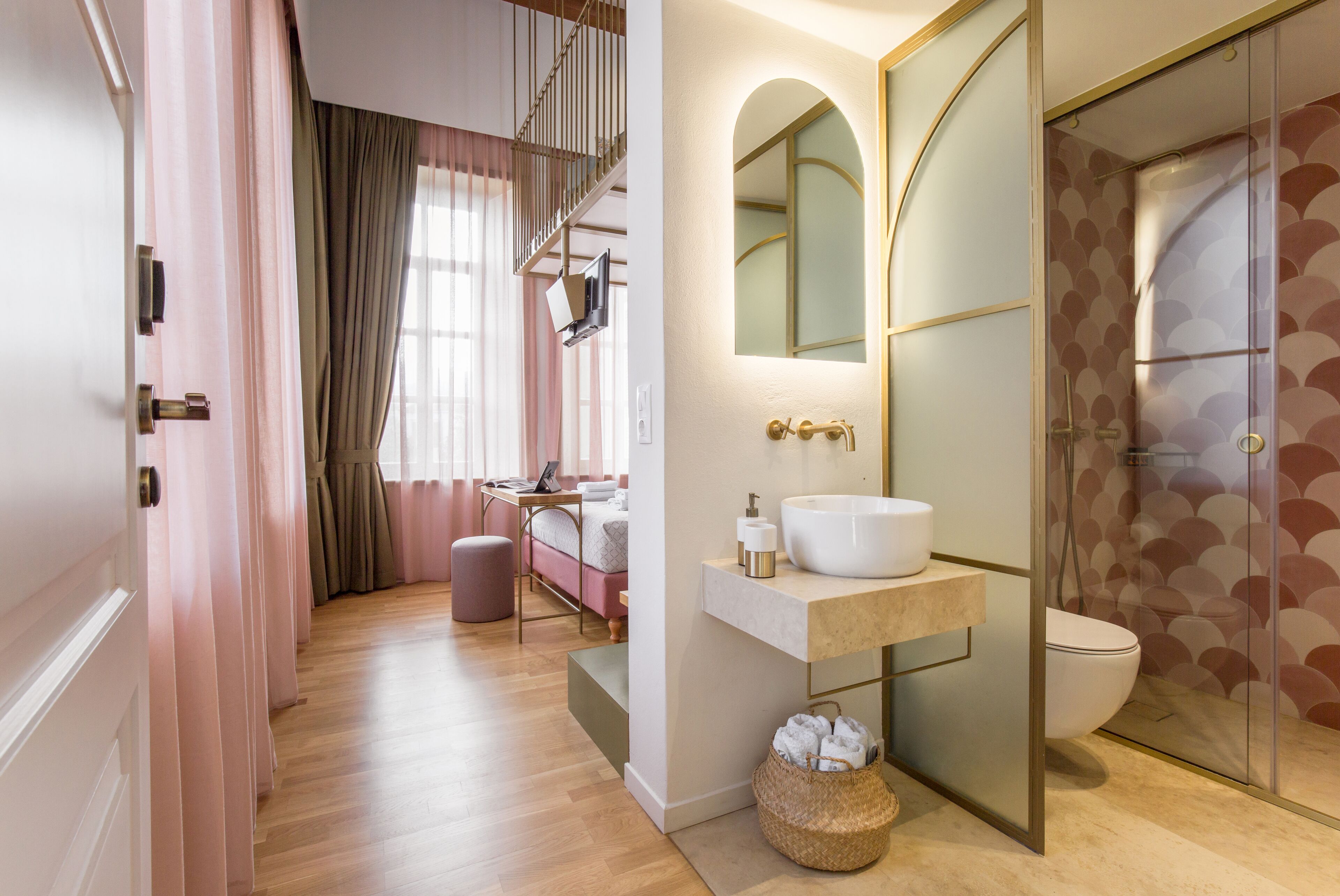 A modern bathroom with a vanity, sink, mirror, and shower.