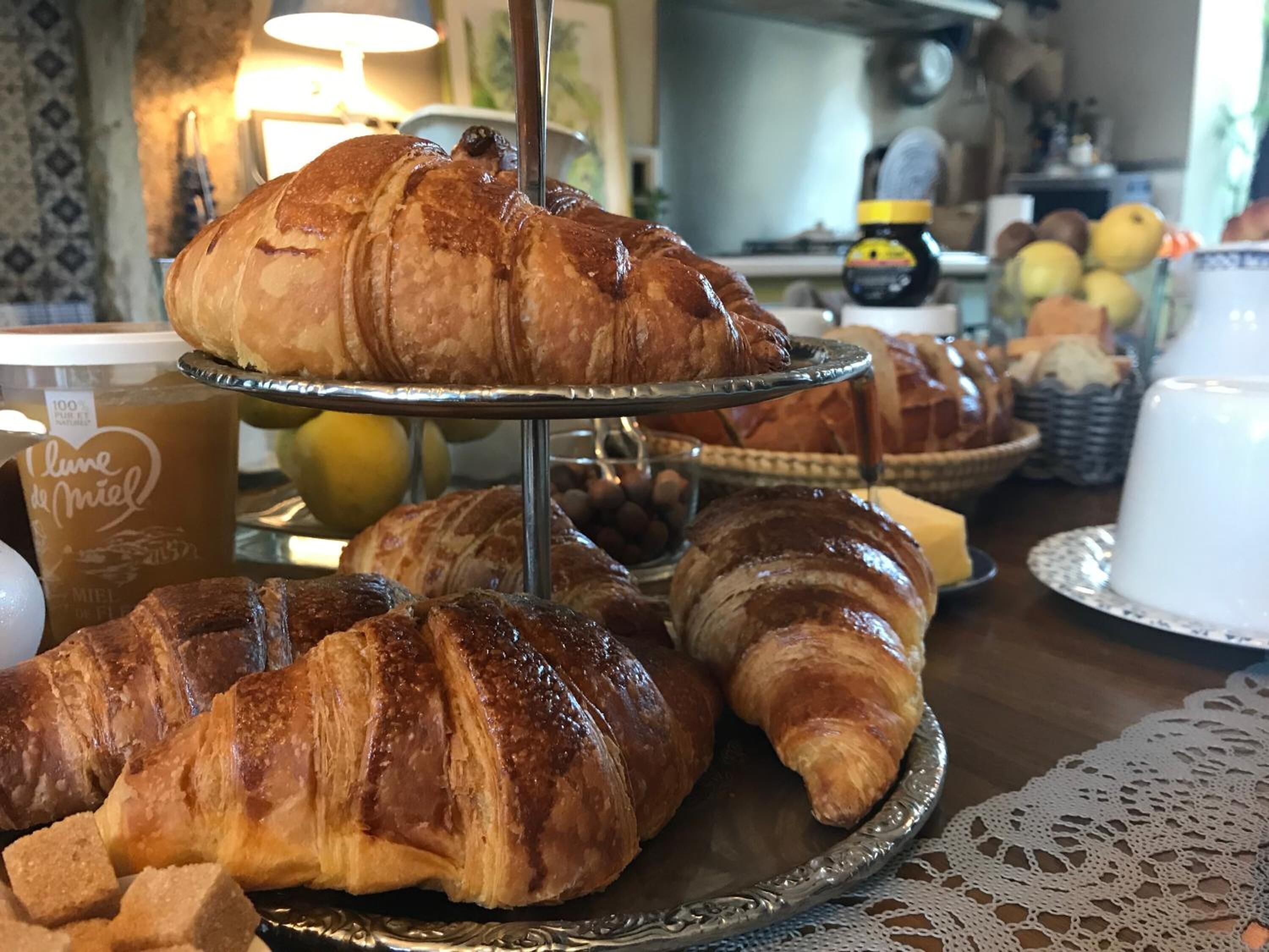 A display of croissants and a coffee cup labeled "Lune de Miel" in a bakery setting.