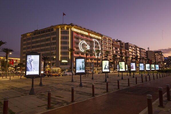 A hotel with multiple floors, illuminated signage, and several digital information boards. - Izmir Palas Otel (Izmir)