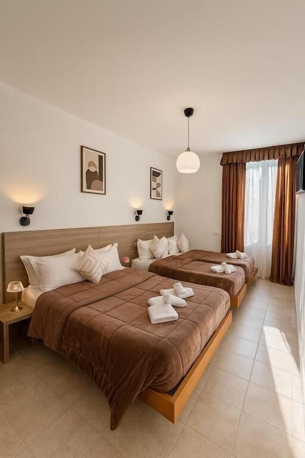 Economy Quadruple Room | In-room safe, iron/ironing board, free WiFi, bed sheets
