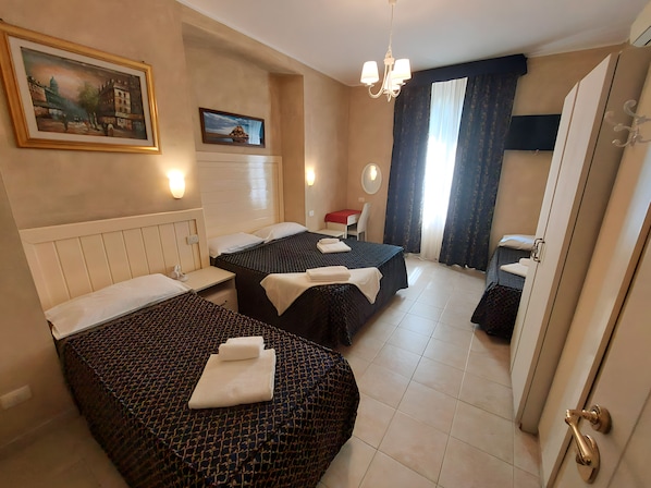 Economy Quadruple Room | In-room safe, iron/ironing board, free WiFi, bed sheets