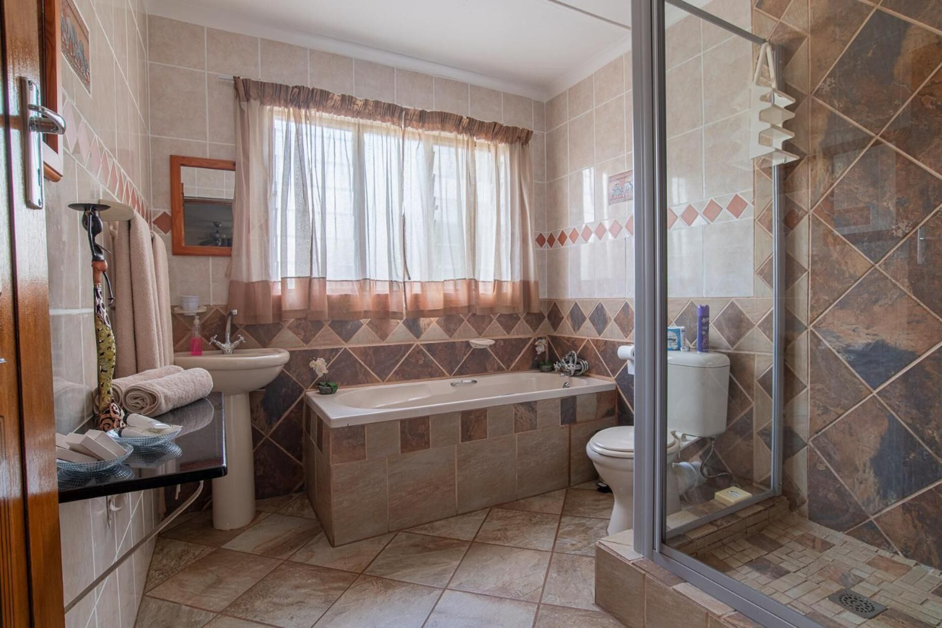 A bathroom with a bathtub, sink, and toilet.