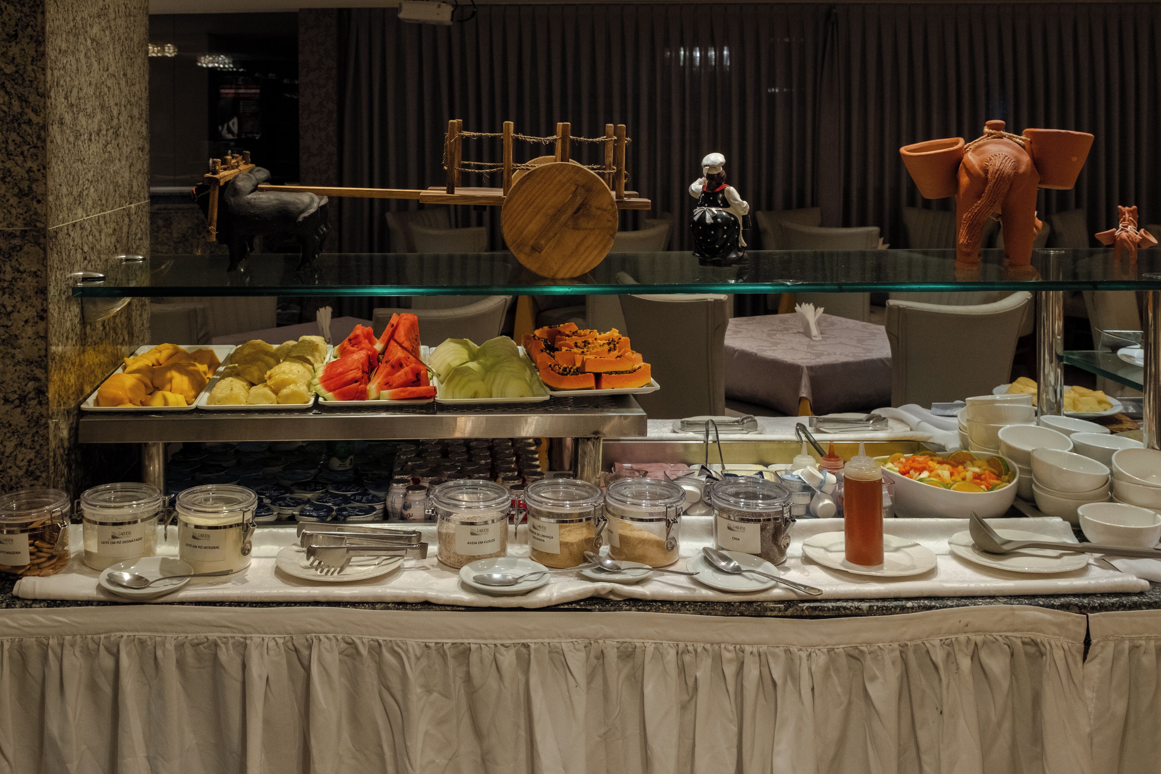 A buffet setup with various food items and condiments.