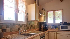 A kitchen with a Bosch dishwasher, a sink, an oven, and a microwave. - Relaxing Retreat in Saint-Pons (Saint Pons)