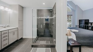 A modern bathroom with a glass-enclosed shower, a vanity with a mirror, and a bathtub. - 62sl - Hot Tub - Wifi - Fireplace - Pets Ok 3 Bedroom Home by RedAwning (Deming)