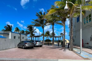 Stroll along the palm-lined street, surrounded by a tranquil atmosphere.