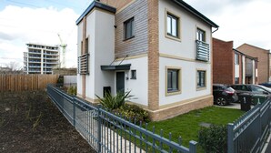 A two-story residential building with a modern design, featuring a brick facade and large windows. - KVM - Quayside House (Peterborough)