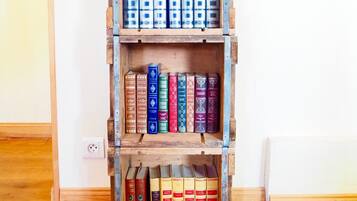 Una estantería de madera con varios estantes llenos de libros.