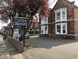 A hotel named 'The Clee Hotel' with a signboard indicating it offers vacancies.