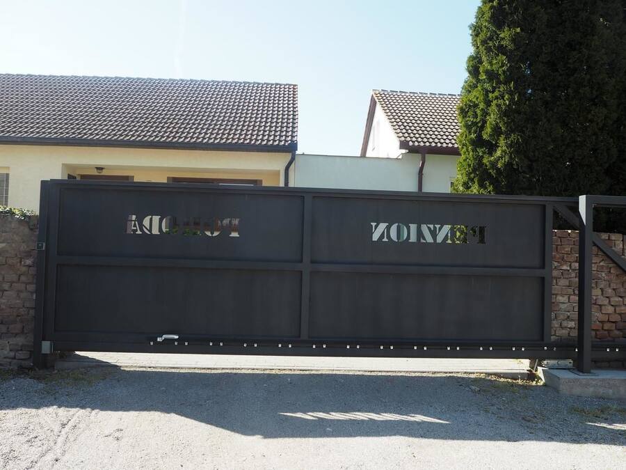 A gated entrance with the words "AOTTO" and "YONOV" on the gate.