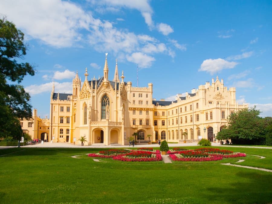 A large, ornate building with a symmetrical facade, multiple towers, and a central entrance.