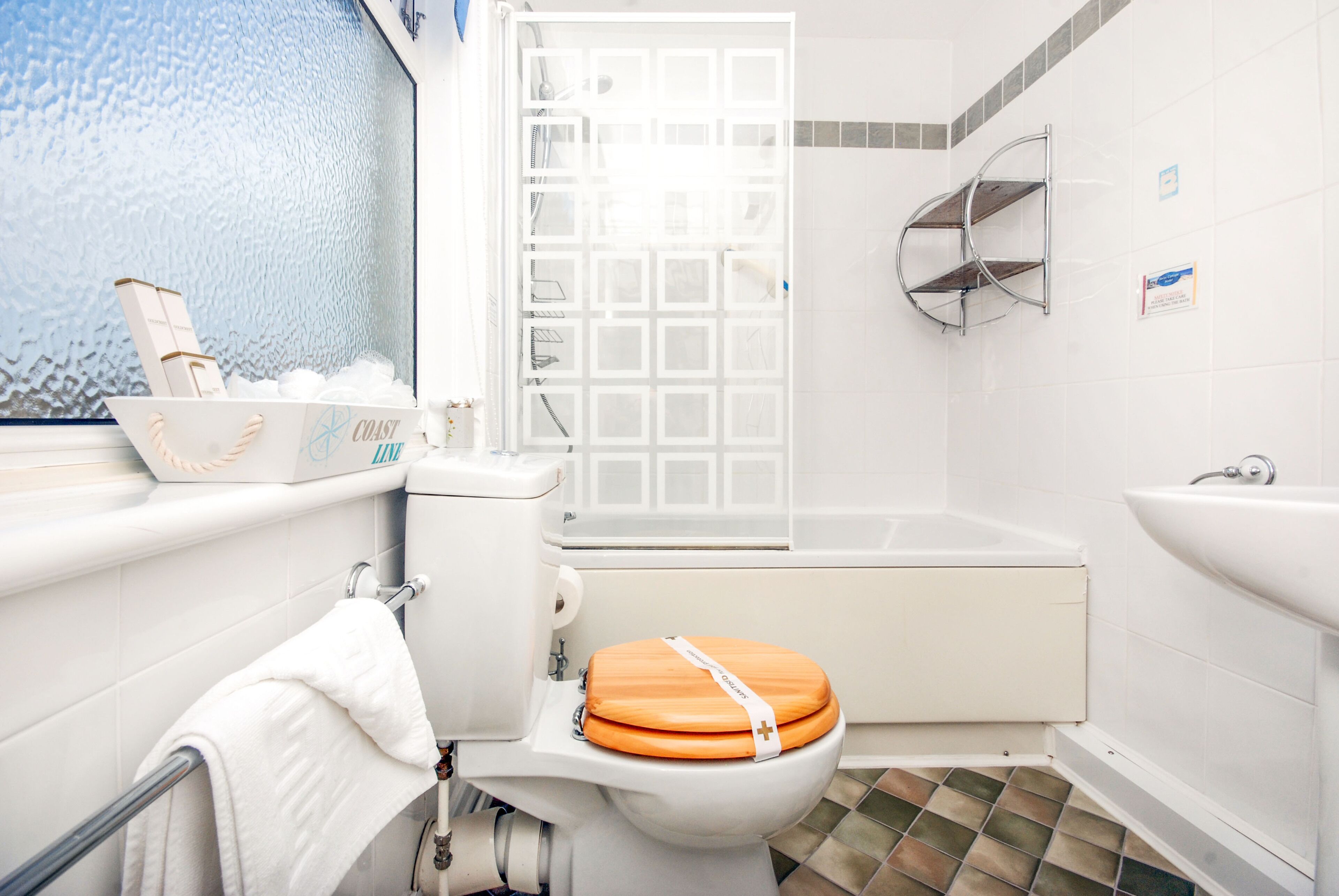 A bathroom with a toilet, a bathtub, a shower, and a sink.