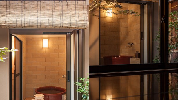 A traditional Japanese-style entrance with a sliding door, a wooden bench, and a large ceramic bathtub. - Private Residence Nijo-jo Nagomi (Kyoto)