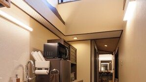 A narrow kitchen with a microwave, refrigerator, and sink. - Private Residence Nijo-jo Nagomi (Kyoto)