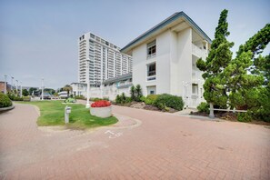 A modern building with a flat roof and a large balcony area. - Chic Virginia Beach Retreat - Pool, Steps to Beach (Virginia Beach)