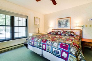 A bedroom with a large bed, two bedside lamps, a window with blinds, and a framed picture on the wall. - 1 Mi to Big Boulder: Lakefront Unit w/ Pool Access (Lake Harmony)