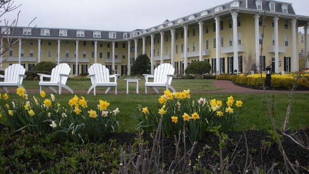 A large building with a symmetrical facade, multiple columns, and a central entrance. - Heart of Jackson St-4BR Victorian Unit just steps to Beach and Mall with Parking (Cape May)