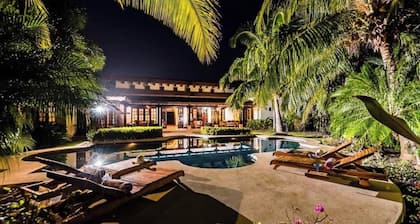 Spacious 4BR home with a private bathroom in every room, large pool, lush gardens, and a terrace with pool views.