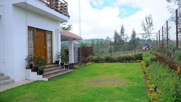 Stunning two-story home with a beautifully manicured lawn and lush greenery.