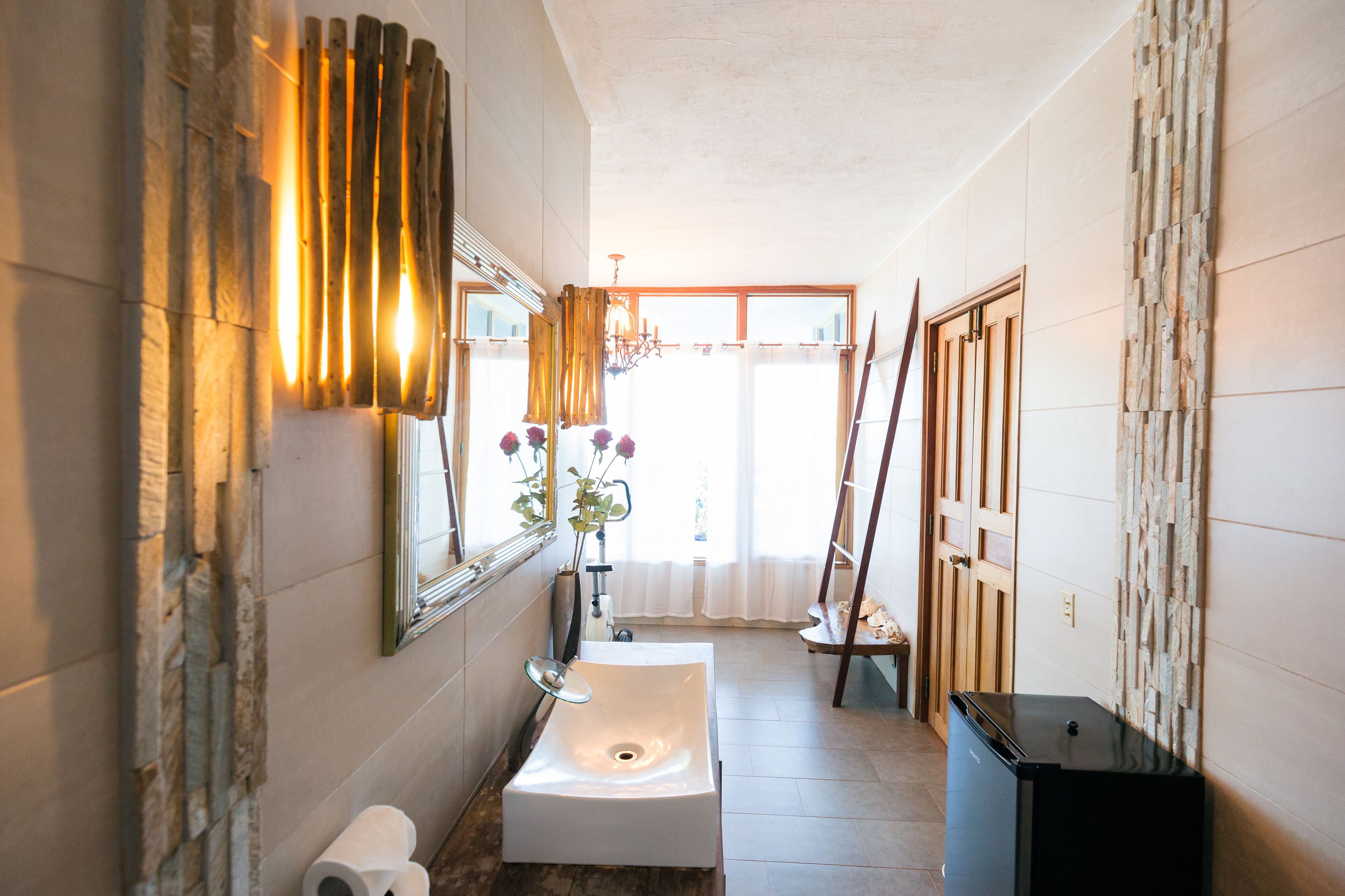A bathroom with a white sink, a mirror, a towel, and a toilet.
