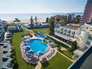 A hotel with a swimming pool, beach view, and multiple balconies. - Flamingo Beach (Nessebar)