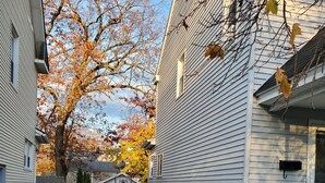 A narrow street flanked by two-story houses with a garage and a small tree. - Cozy & Spacious Entire Home in Springfield (Springfield)