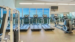 A gym with treadmills, exercise bikes, and a rowing machine. - Balcony Ocean Views | Pool, Gym, Wi-Fi & Parking (Miami)