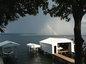 Relax on a serene lakeside deck with a covered area perfect for dining or unwinding.