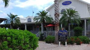A building with a sign for 'Pier One Yacht Sales' and a contact number. - GOLF  BOATING BIKING (Punta Gorda)